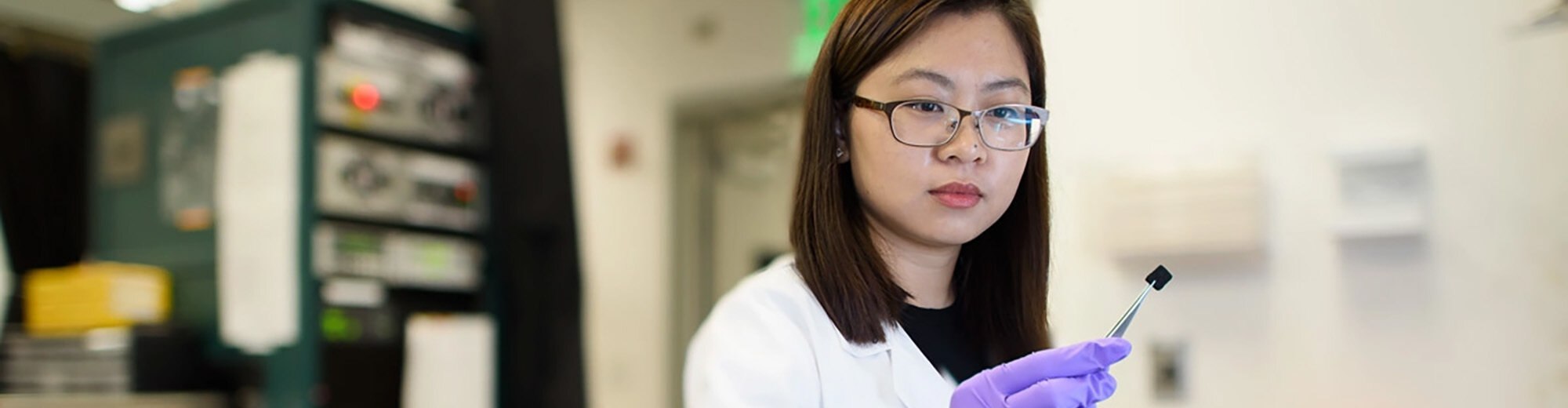 Postdoctoral scholar Chong Liu examines a carbon-amidoxime electrode as part of research to improve extraction of uranium from seawater