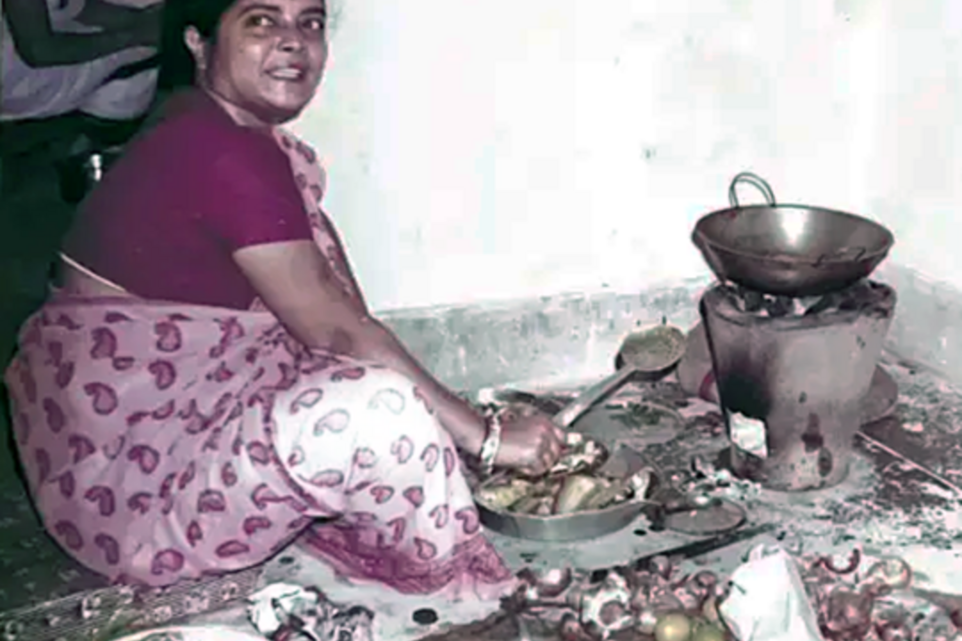 Arun Majumdar's mother using a floor coal stove