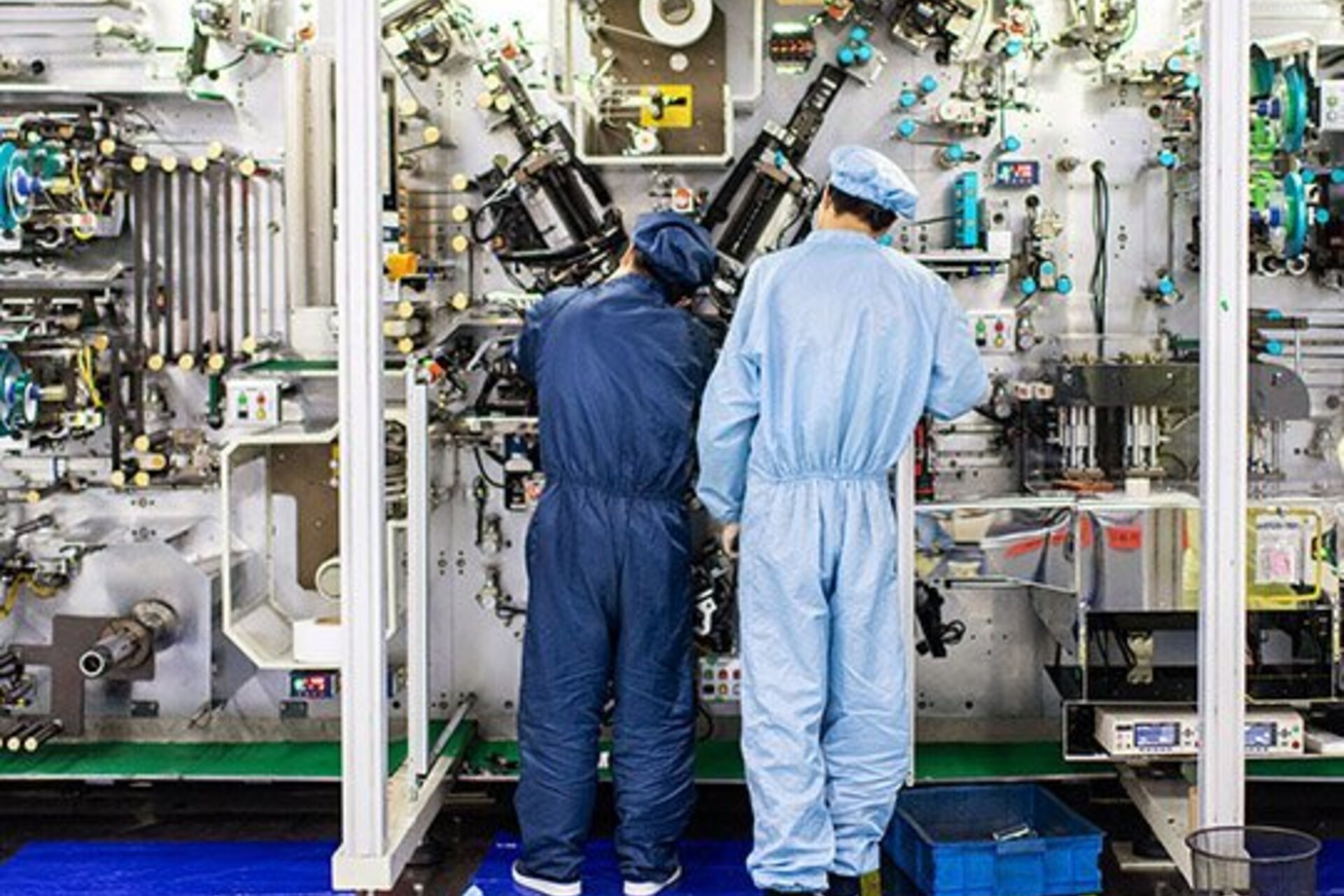 At the Amprius factory in Wuxi, China, workers operate a machine that winds together anodes and cathodes to make batteries.