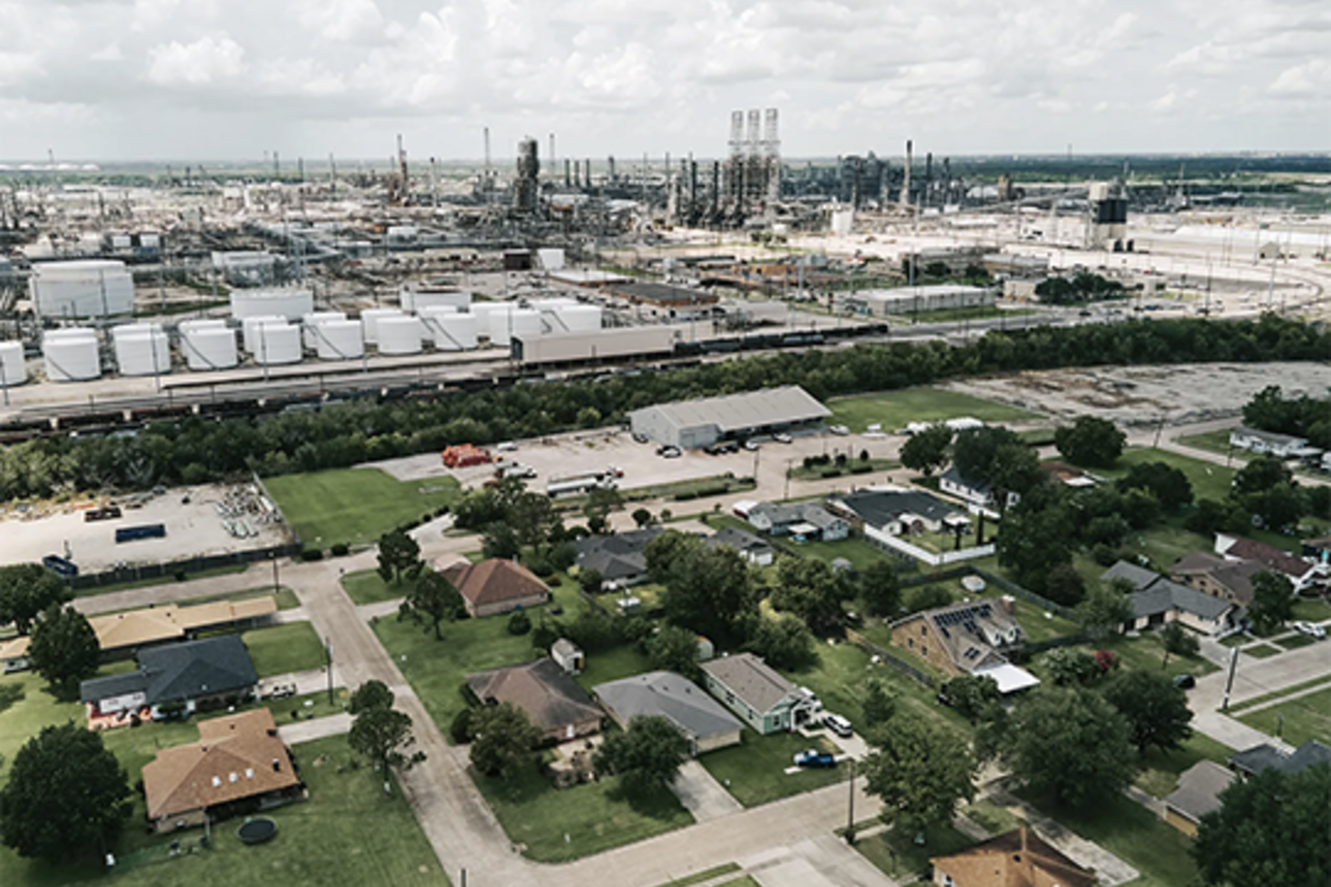 Bird'seye view of Port Arthur showing a residential neighborhood alongside the Motiva Oil Refinery.