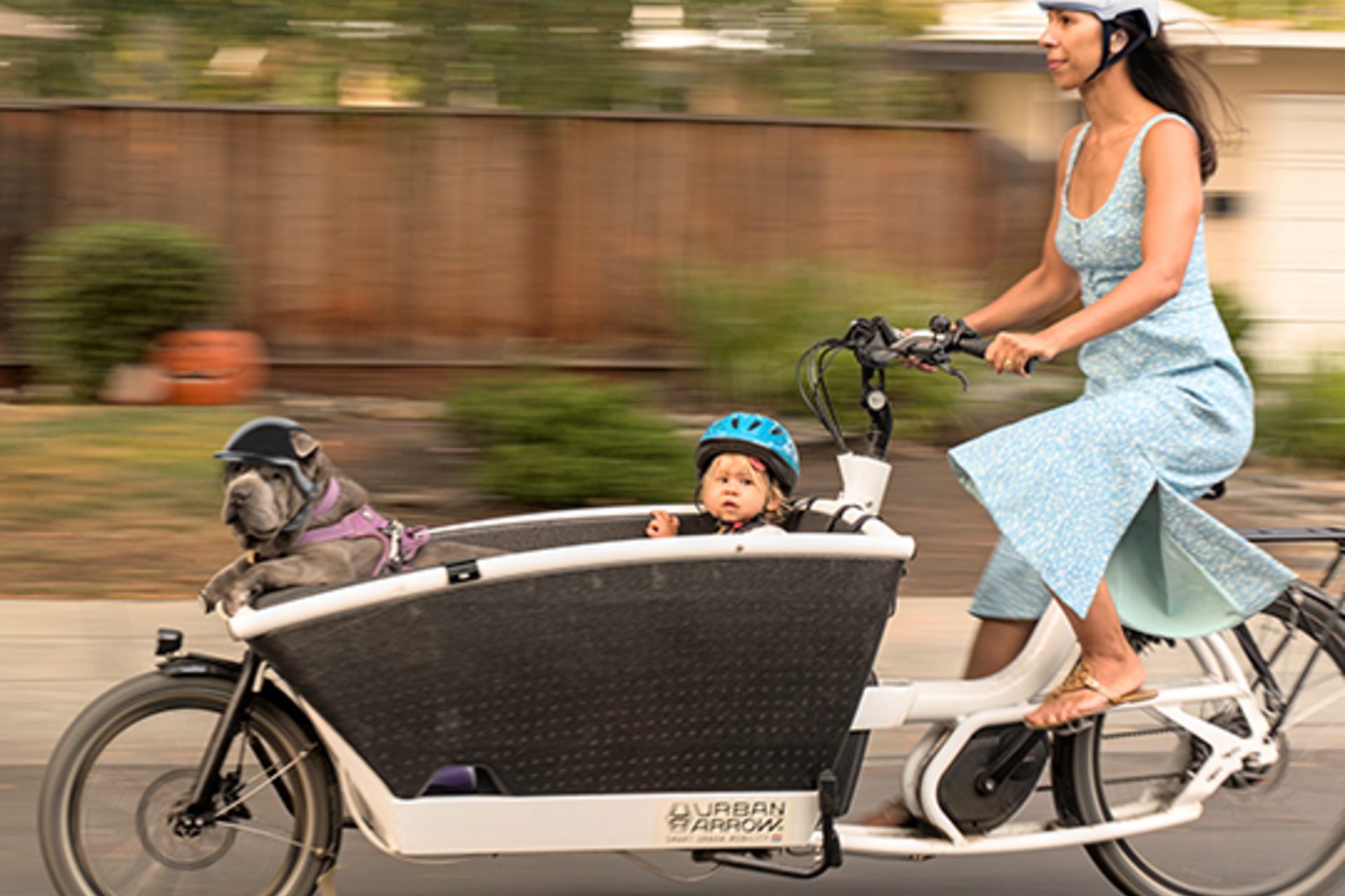 Woman riding bike with child in front