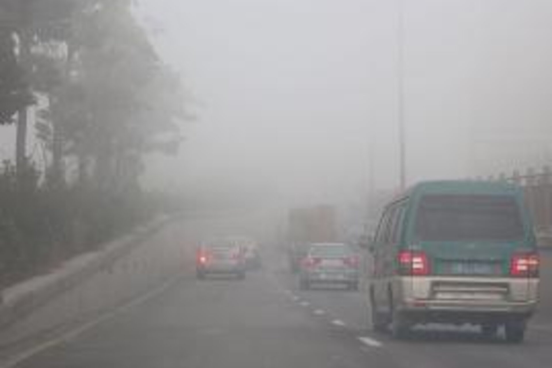 Cars on highway driving through smog