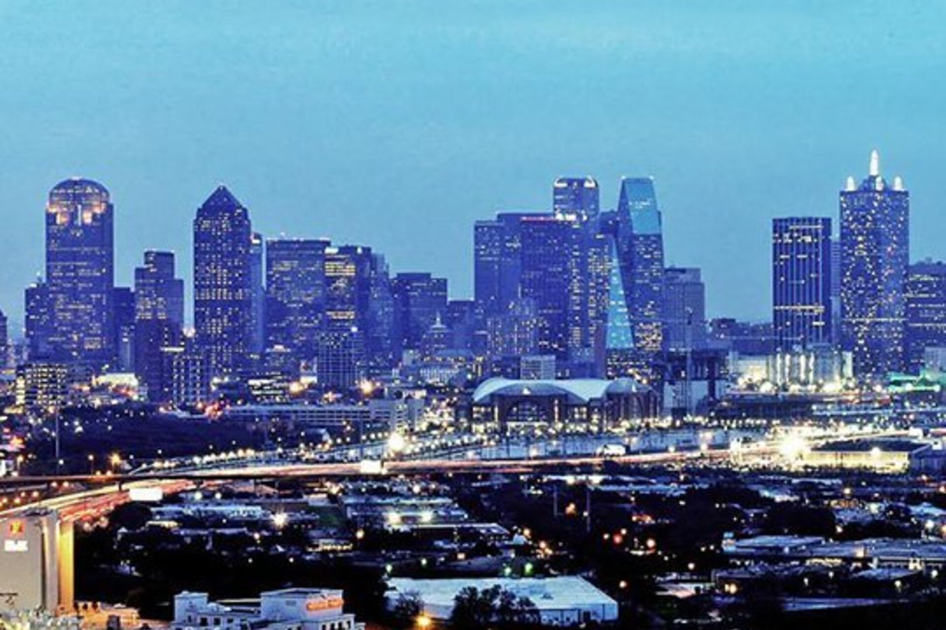 The cityscape of Dallas illuminated at dusk