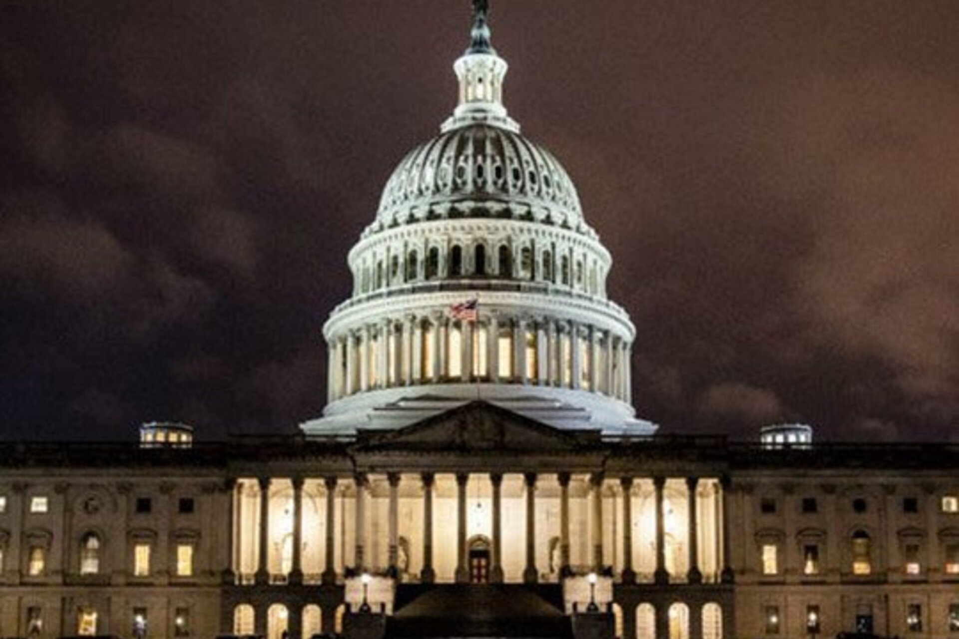 The Capitol building illuminated at night