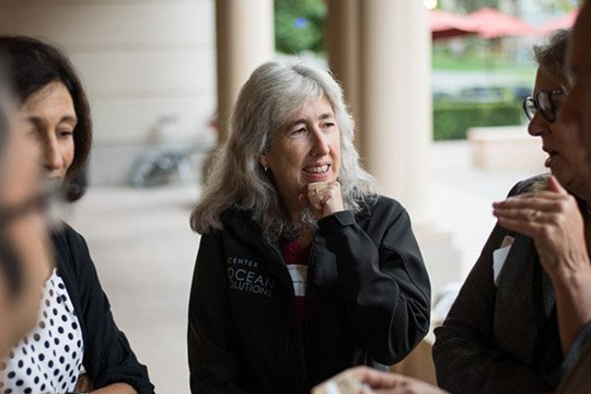 Deborah Sivas talking with colleagues on Stanford's campus