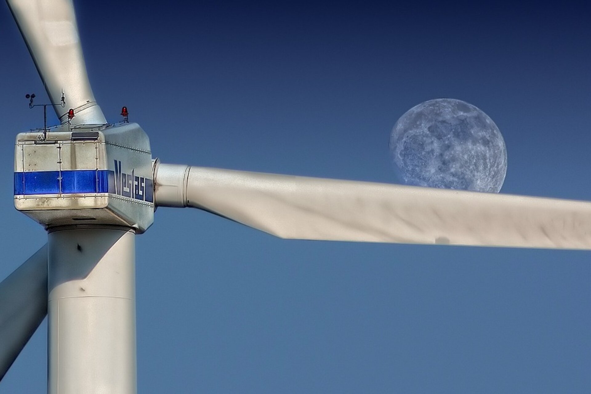 Singe wind turbine with moon in background