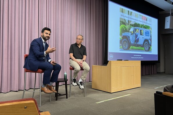 Ali Zaidi and Stephen Chu sitting on high chairs