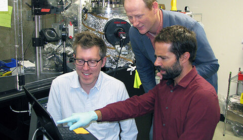 Christopher Graves, Michal Bajdich, and Michael Machala working together in a lab