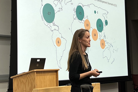 Lauren Culver speaking at podium in front of presentation for her Energy Seminar talk